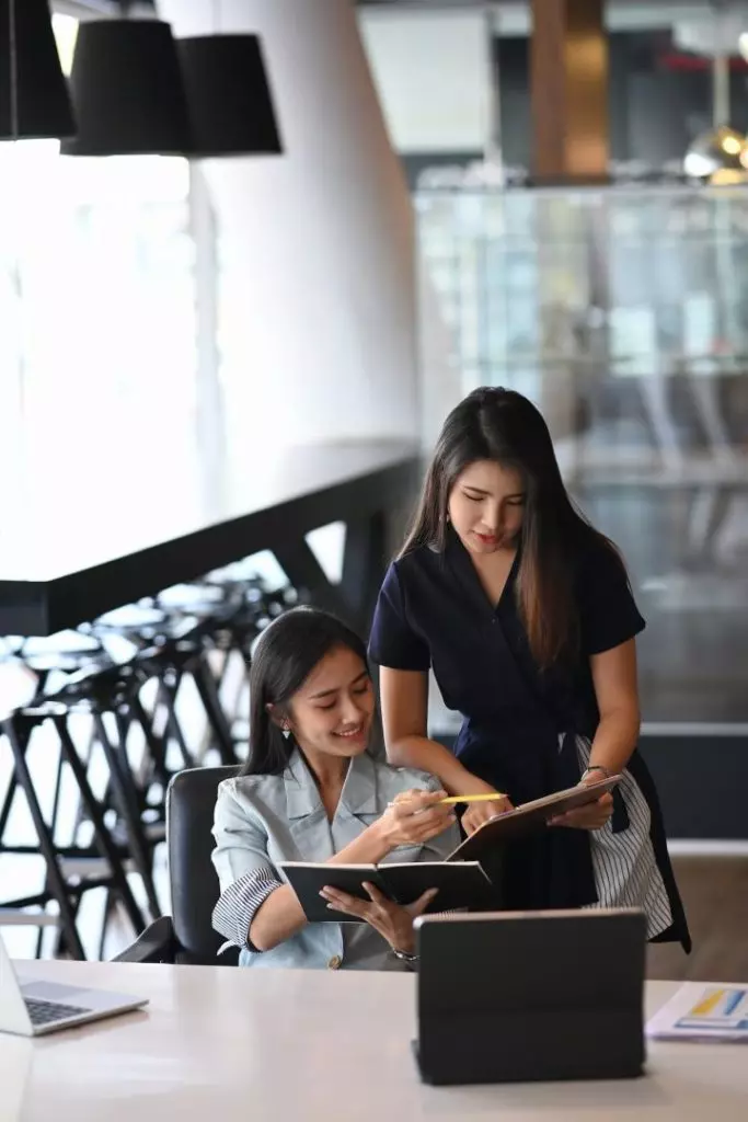 two-young-businesswoman-using-digital-tablet-and-discussing-business-plan--683x1024.jpg